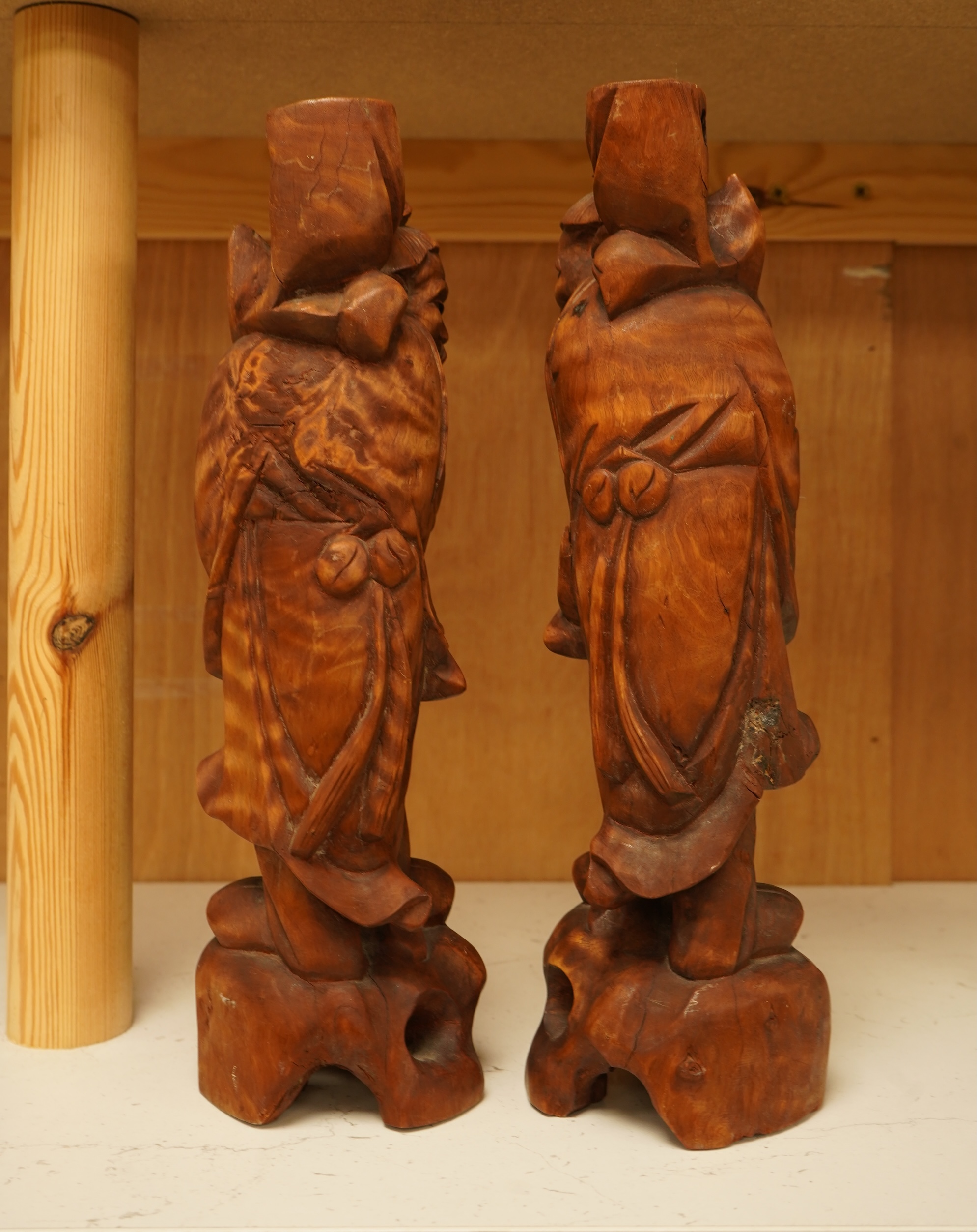 A pair of 20th century Chinese carved wood figures of sages, 31cm